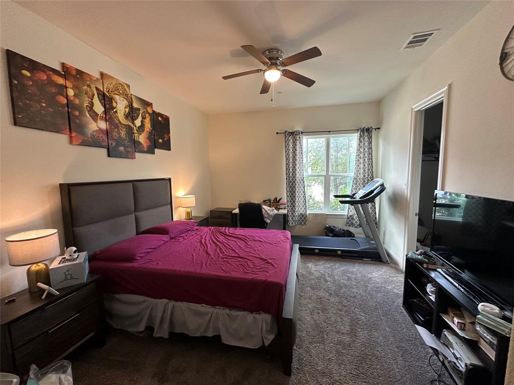 1037 Drew Lane Allen, TX 75013 - Photo 13 of 18 a bedroom with a bed and a flat screen tv