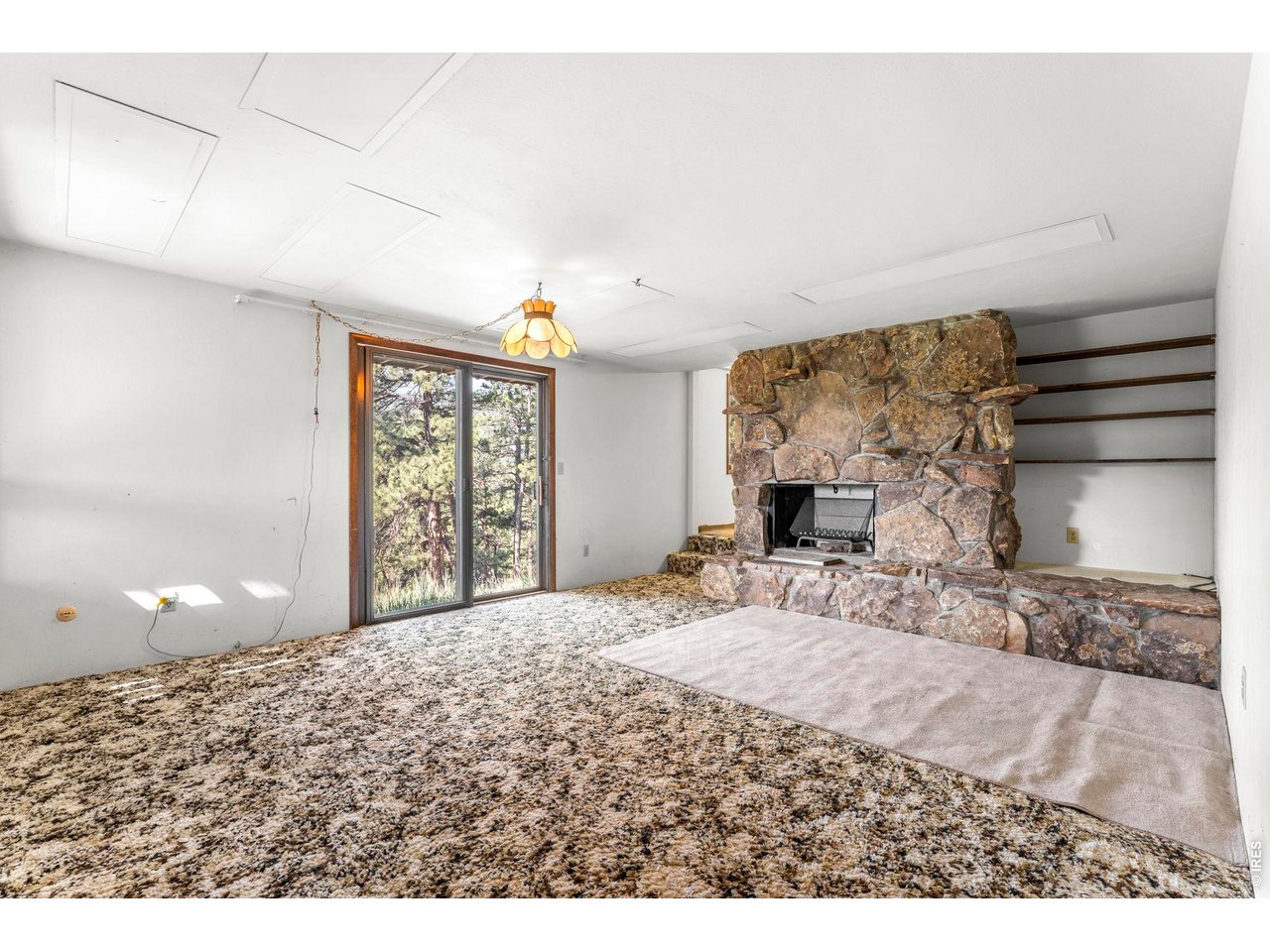402 Broken Fence Road Boulder, CO 80302 - Photo 26 of 44 Lower level moss rock fireplace