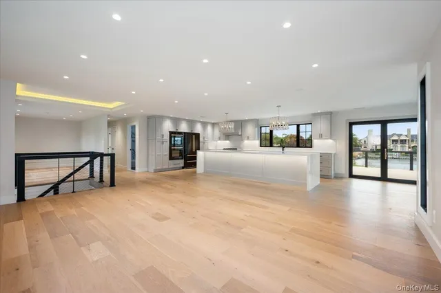 a large kitchen with kitchen island a large counter space stainless steel appliances and cabinets