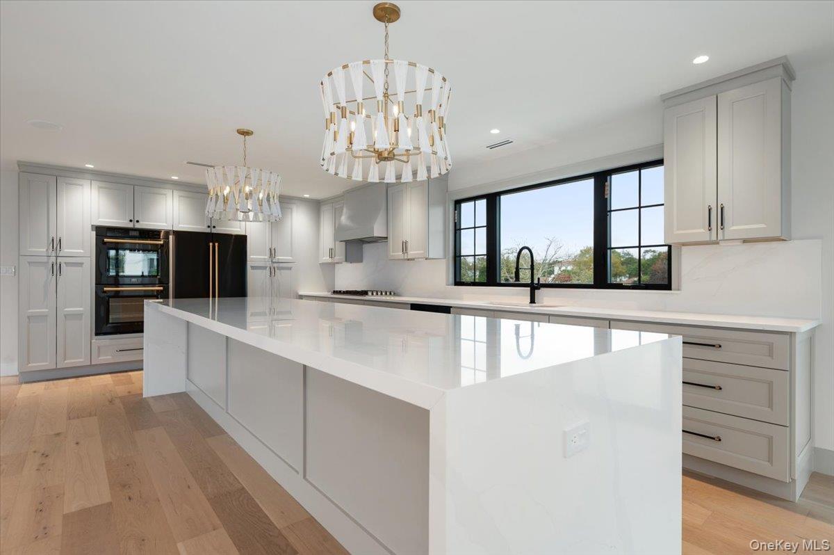 147 West Bayberry Road Islip, NY 11751 - Photo 8 of 31 a large kitchen with kitchen island a large counter space stainless steel appliances and cabinets
