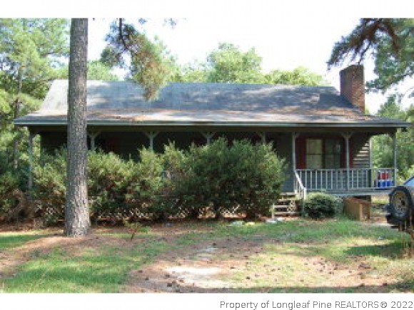 825 Line Road Cameron, NC 28326 - Photo 1 of 1 a front view of a house with garden