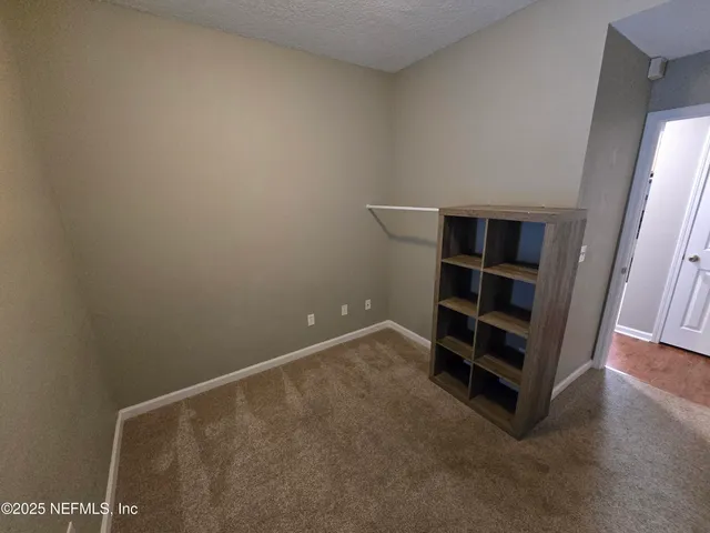 a view of a livingroom with a ceiling fan and window