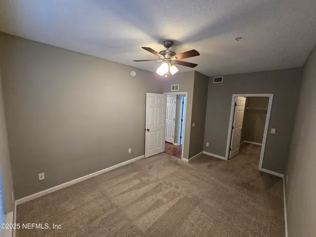 a view of swimming pool with chairs and tables