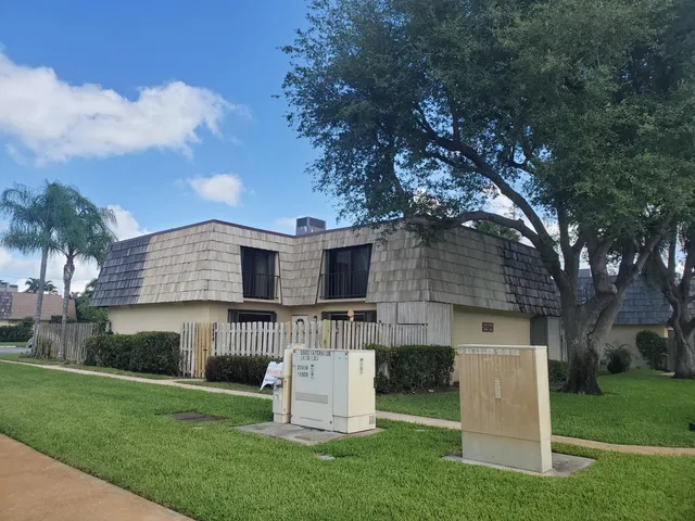 a view of house with backyard space and garden