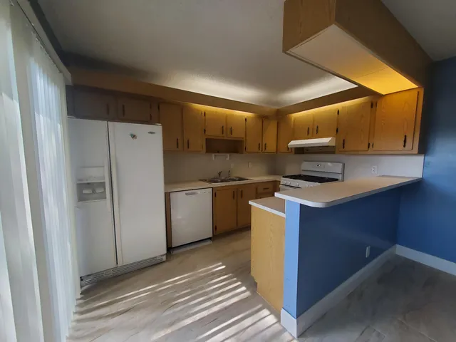 a kitchen with a refrigerator a stove a microwave a sink and cabinets