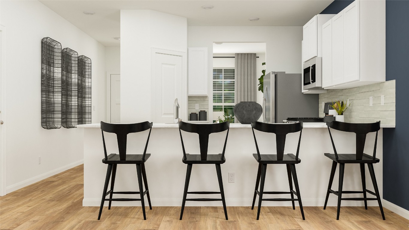 527 Sormonne Loop Kyle, TX 78640 - Photo 15 of 23 a view of a dining room with furniture and wooden floor