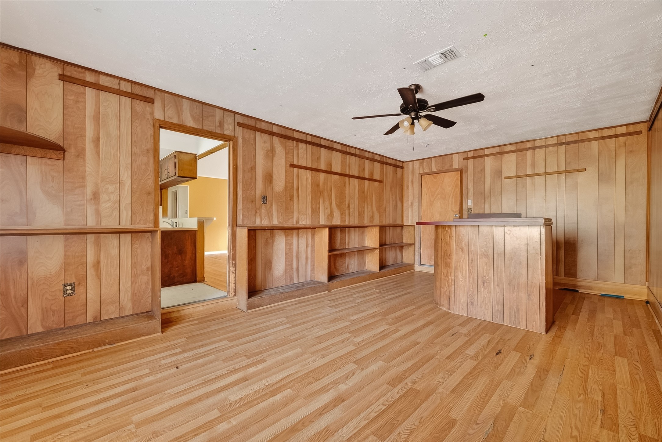 20706 Emerald Street Prairie View, TX 77484 - Photo 18 of 47 a view of a livingroom with wooden floor and a ceiling fan
