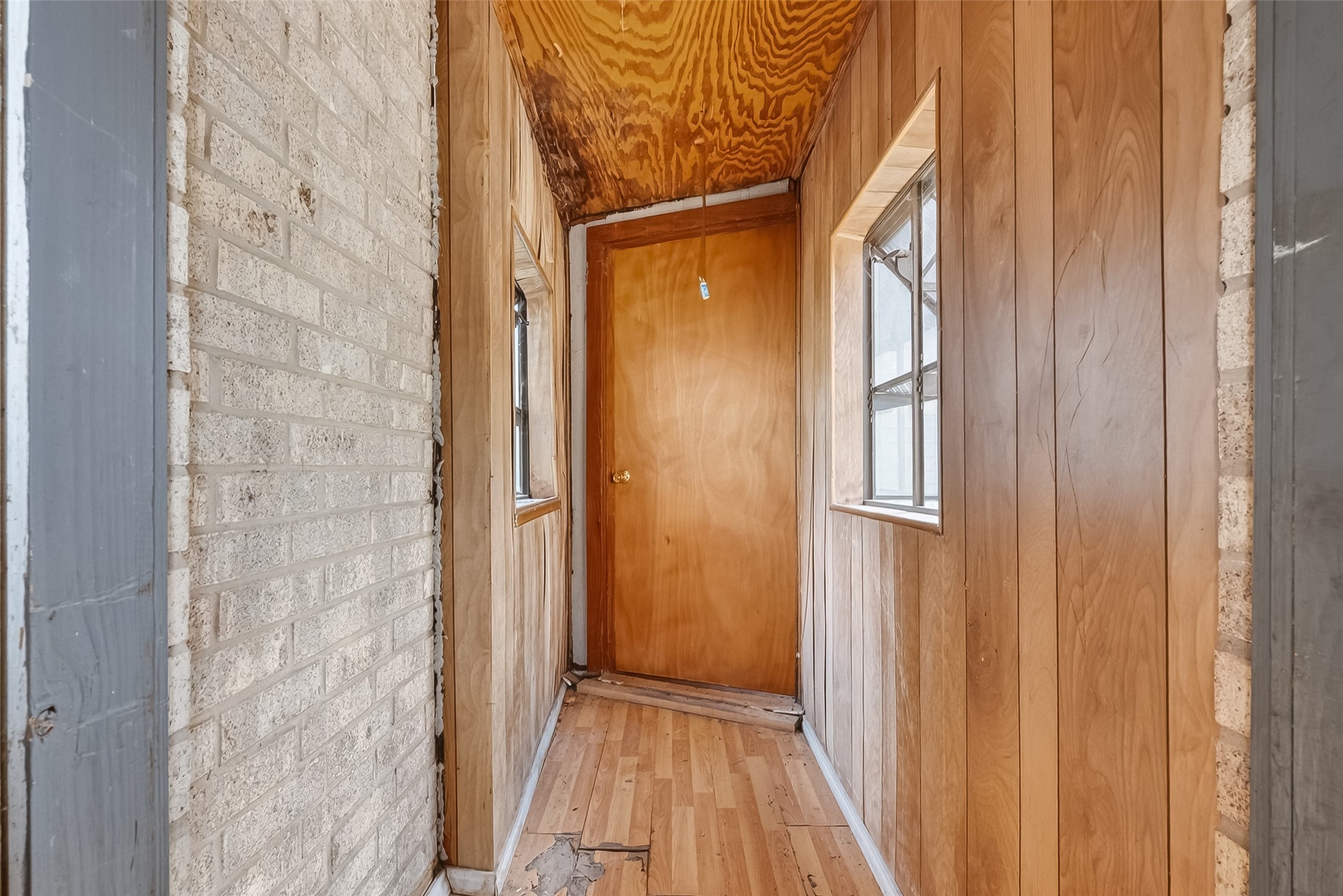 20706 Emerald Street Prairie View, TX 77484 - Photo 22 of 47 a view of a hallway with wooden floor and a bathroom