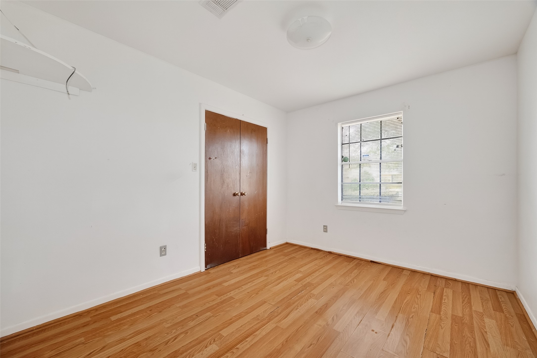 20706 Emerald Street Prairie View, TX 77484 - Photo 36 of 47 an empty room with wooden floor and windows