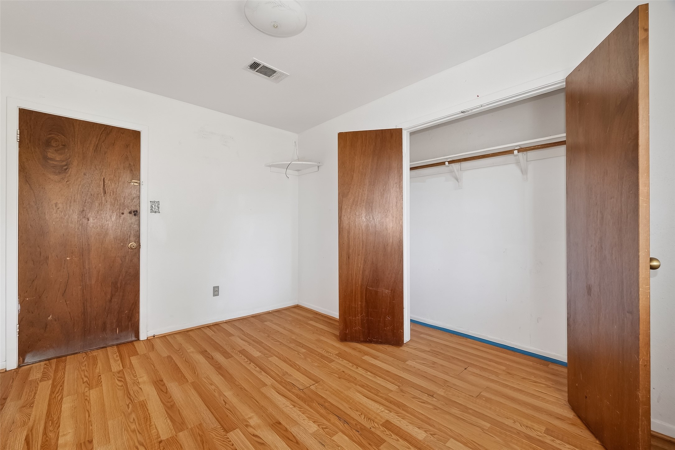 20706 Emerald Street Prairie View, TX 77484 - Photo 38 of 47 a view of an empty room with wooden floor and a bathroom