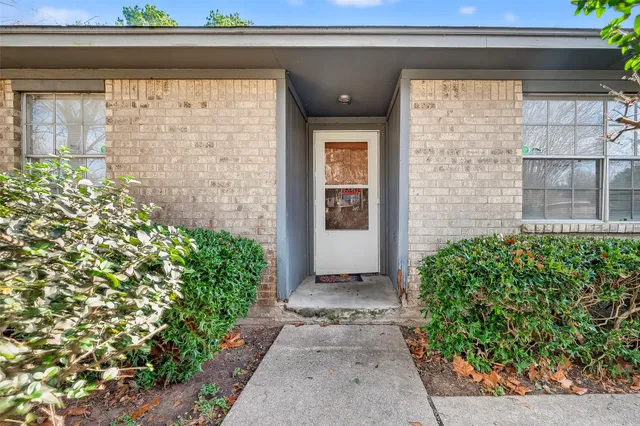 a kitchen with granite countertop a refrigerator and a sink