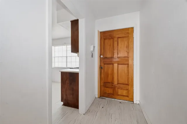 a view of a livingroom with wooden floor and a ceiling fan