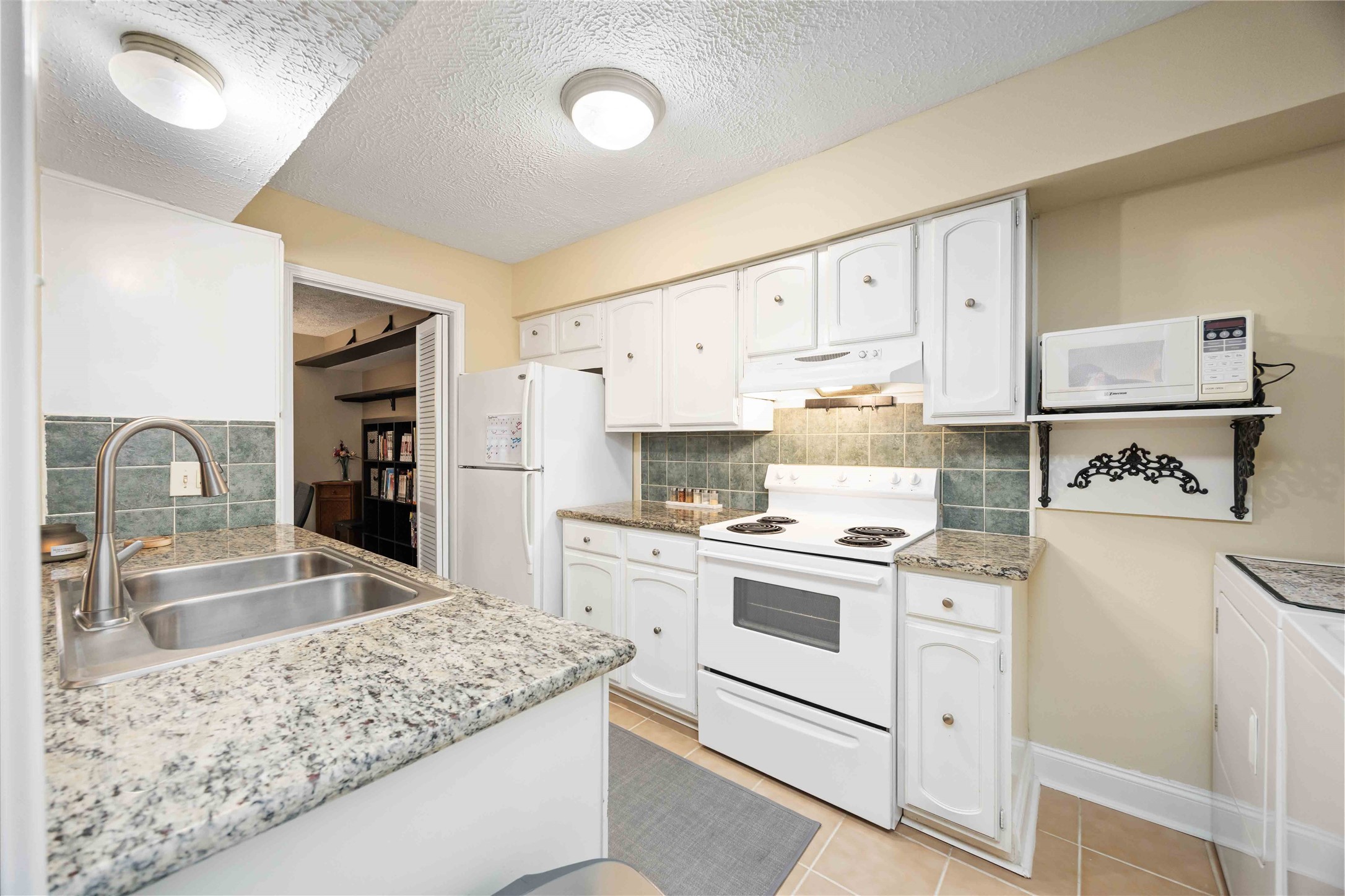 454 North Post Oak Lane Houston, TX 77024 - Photo 11 of 22 a kitchen with granite countertop a sink stove and refrigerator