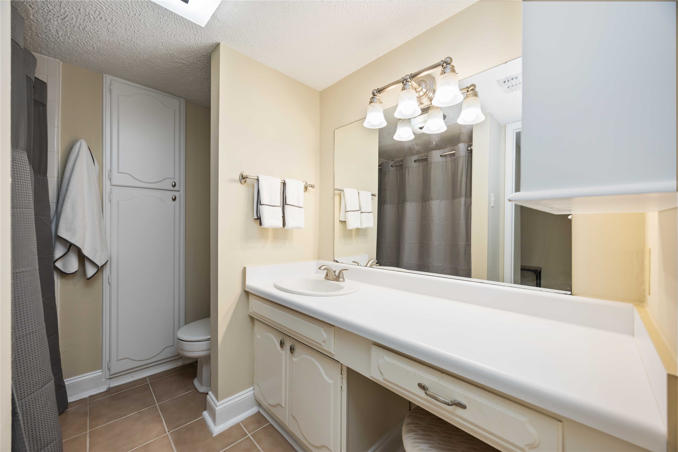 454 North Post Oak Lane Houston, TX 77024 - Photo 13 of 22 a bathroom with a sink vanity mirror and toilet