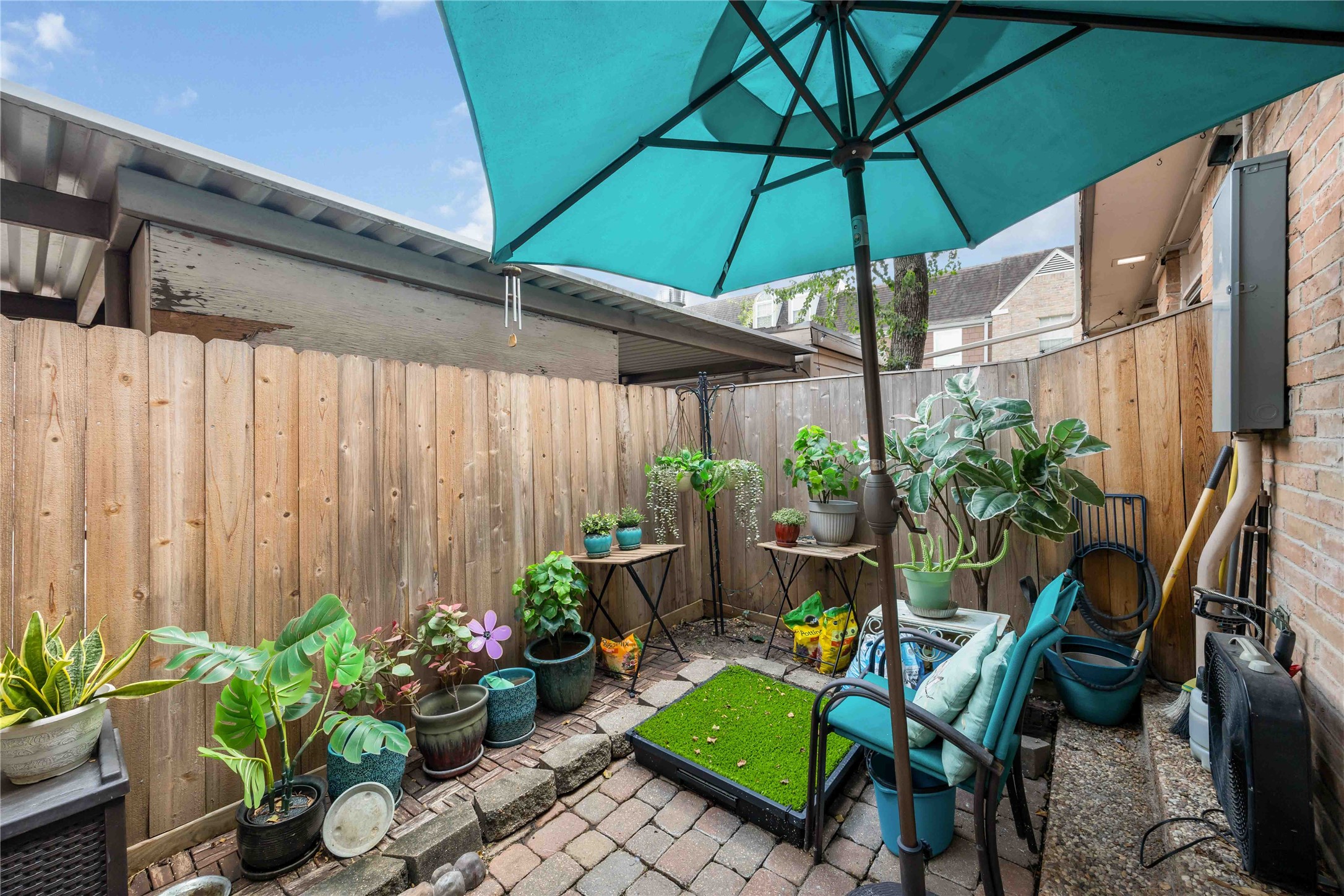 454 North Post Oak Lane Houston, TX 77024 - Photo 17 of 22 a view of a backyard with furniture and a umbrella
