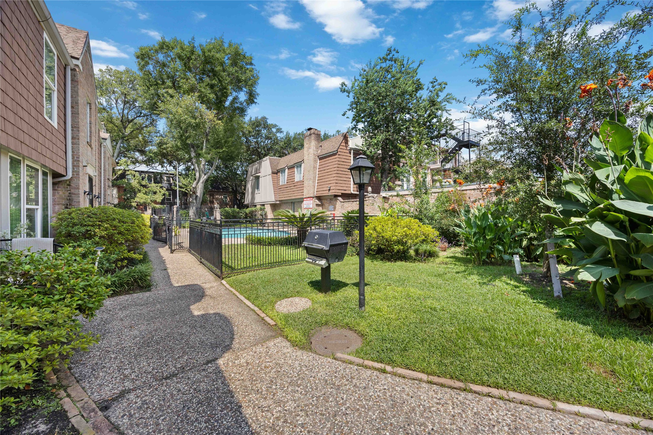 454 North Post Oak Lane Houston, TX 77024 - Photo 21 of 22 a view of a park with plants and a bench