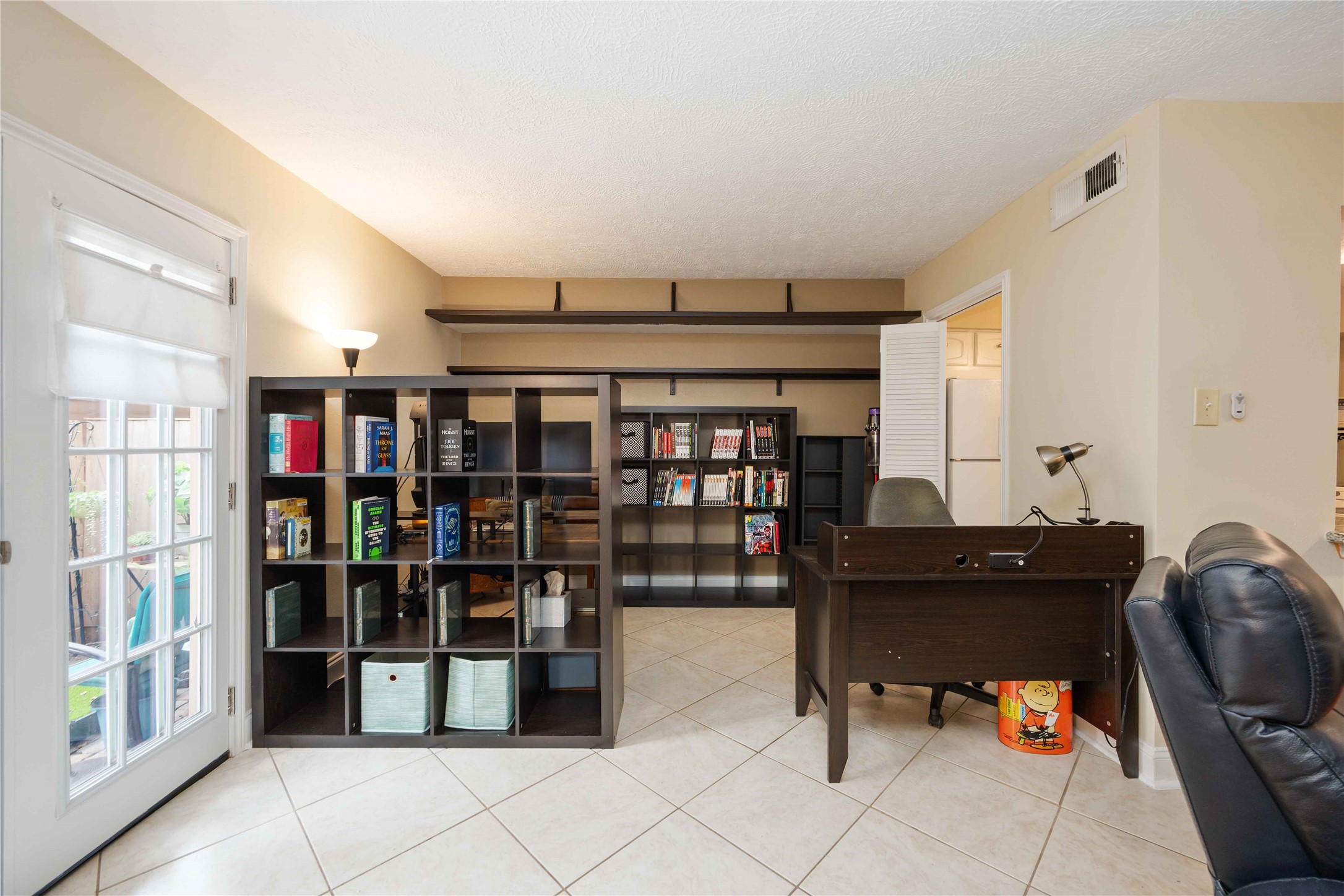 454 North Post Oak Lane Houston, TX 77024 - Photo 10 of 22 a room with wine cabinets and has a bookshelf