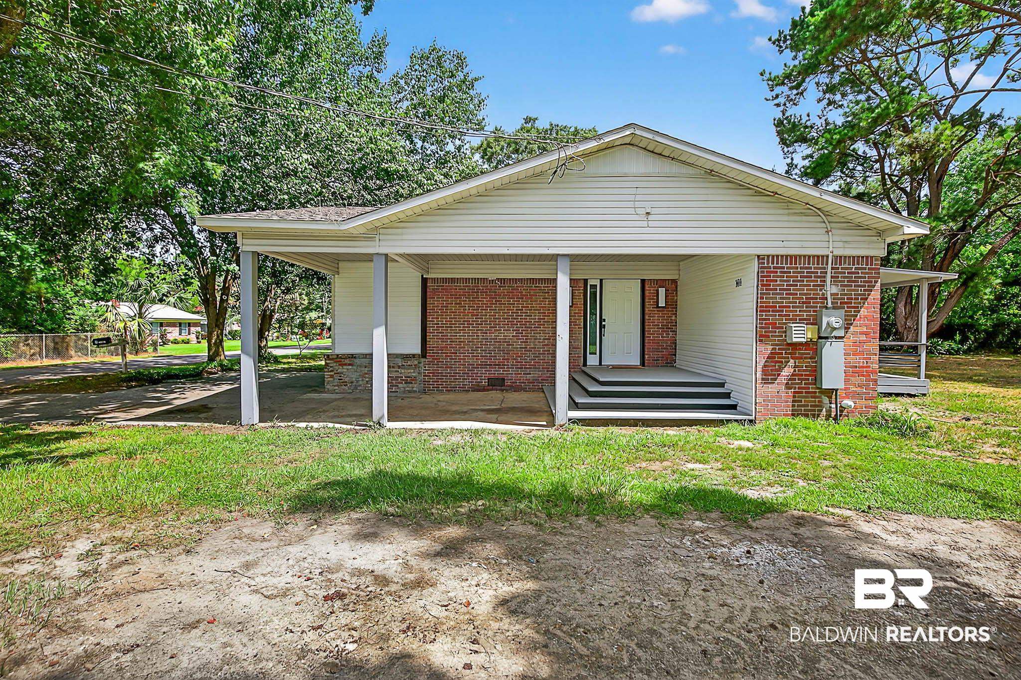 101 Terry Avenue Brewton, AL 36426 - Photo 3 of 48 View of front of home featuring brick siding, covered porch, and crawl space