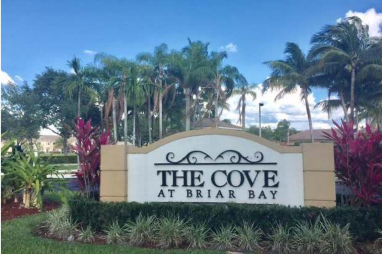 3501 Briar Bay Boulevard, Unit 205 West Palm Beach, FL 33411 - Photo 1 of 8 a sign that is on the side of the road