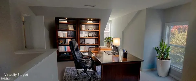 a view of a workspace with furniture and a potted plant