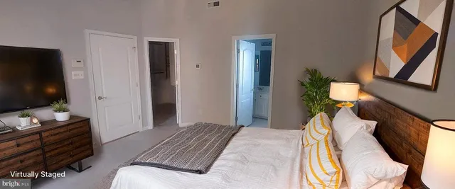 a bedroom with a bed and flat screen tv