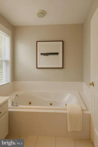 a bathroom with bathtub and window
