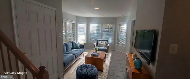a living room with furniture and a floor to ceiling window