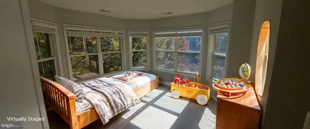 a bedroom with bed and a window