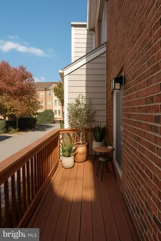 a view of a balcony with chairs and wooden floor