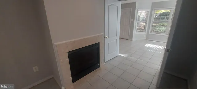a view of an empty room with a fireplace