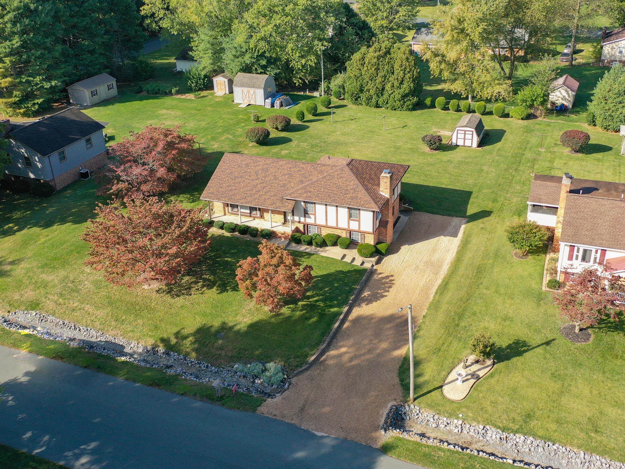 an aerial view of a house with garden space and street view
