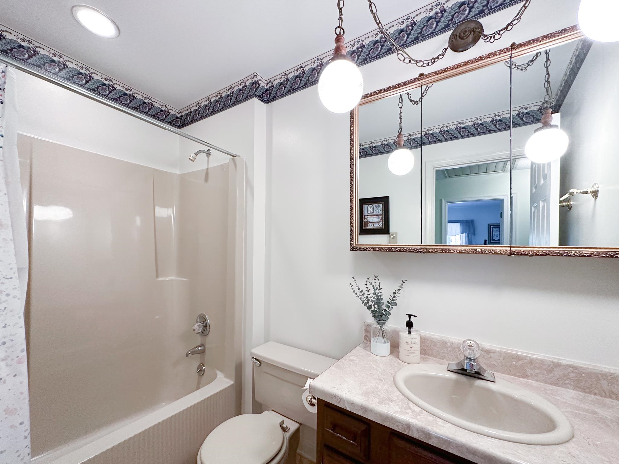 53 Cooper Drive Stuarts Draft, VA 24477 - Photo 23 of 31 a bathroom with a sink toilet a mirror and shower