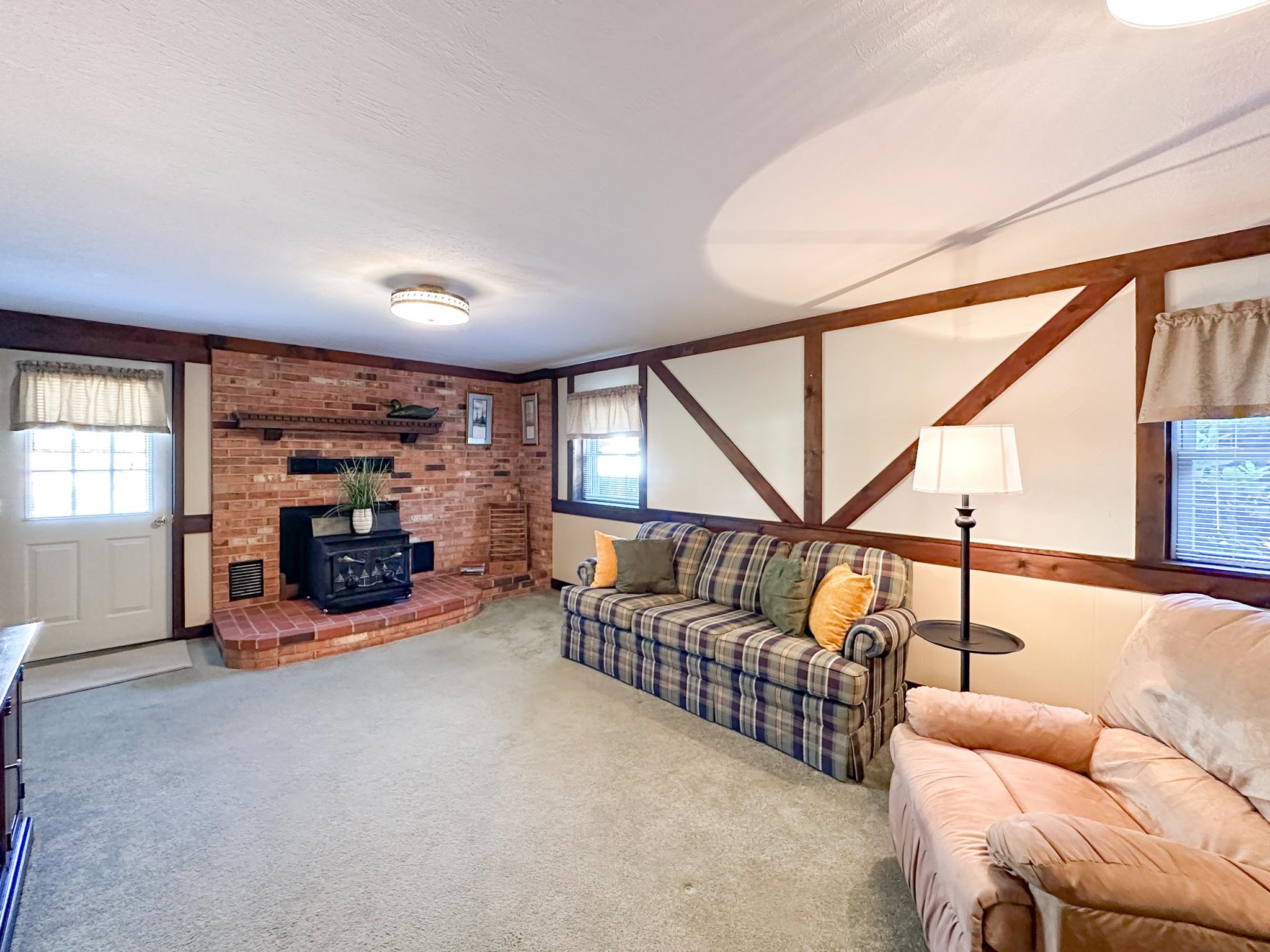 53 Cooper Drive Stuarts Draft, VA 24477 - Photo 26 of 31 a living room with furniture a fireplace and gym equipment