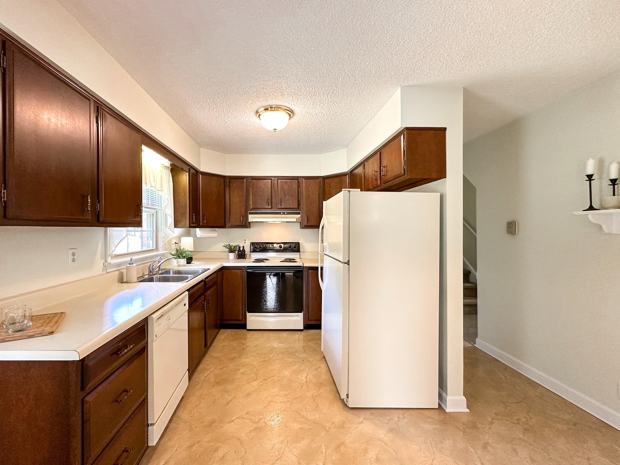 53 Cooper Drive Stuarts Draft, VA 24477 - Photo 9 of 31 a kitchen with a sink a refrigerator and cabinets