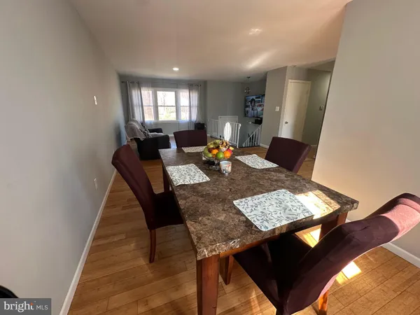 a view of a dining room with a table and chairs