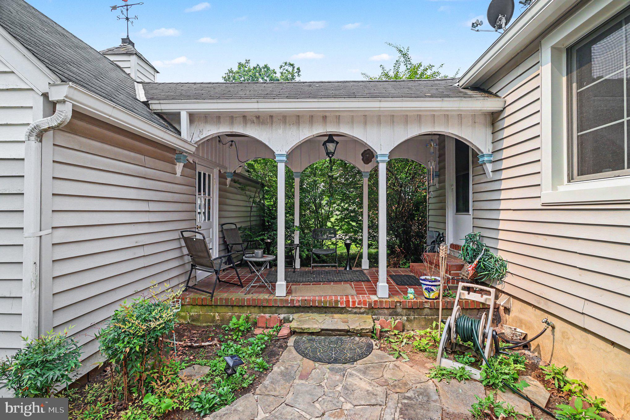 5912 Shady Spring Avenue Baltimore, MD 21237 - Photo 26 of 75 Charming porch with lush greenery.