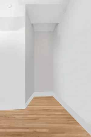 a kitchen with stainless steel appliances a refrigerator and a wooden floor