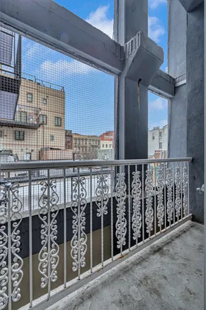 a view of balcony with wooden fence