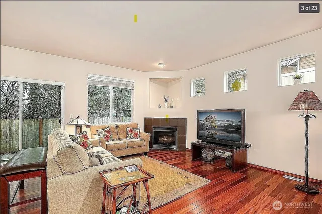 a living room with furniture a flat screen tv and a fireplace