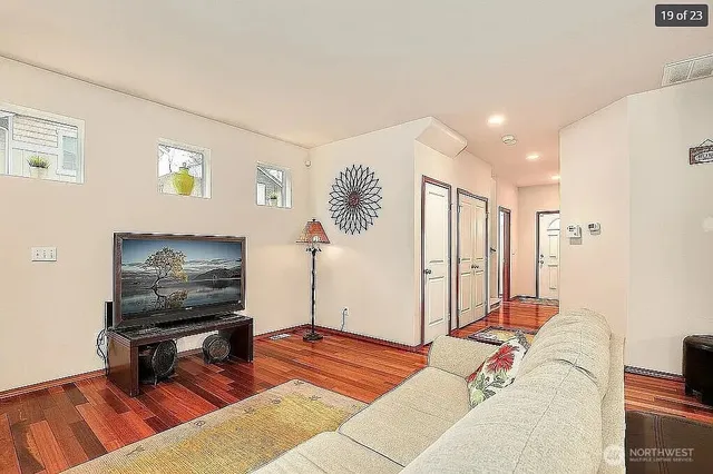 a living room with furniture and a flat screen tv