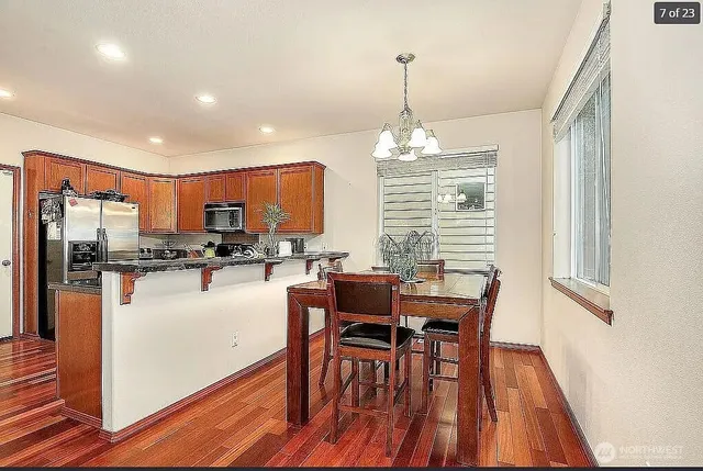 a view of a dining room with furniture window and wooden floor