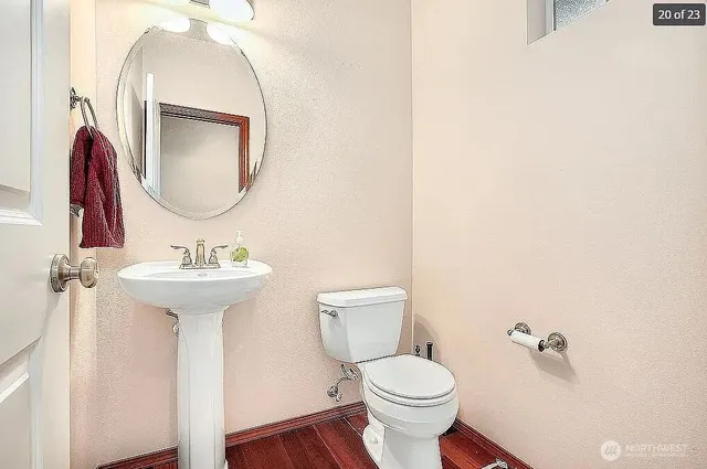 a bathroom with a toilet sink and mirror