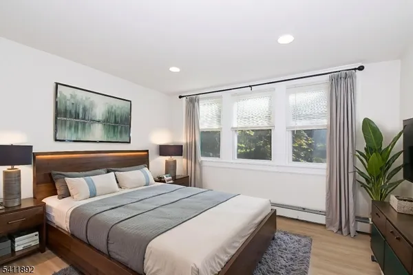 a bedroom with a large bed and a large window