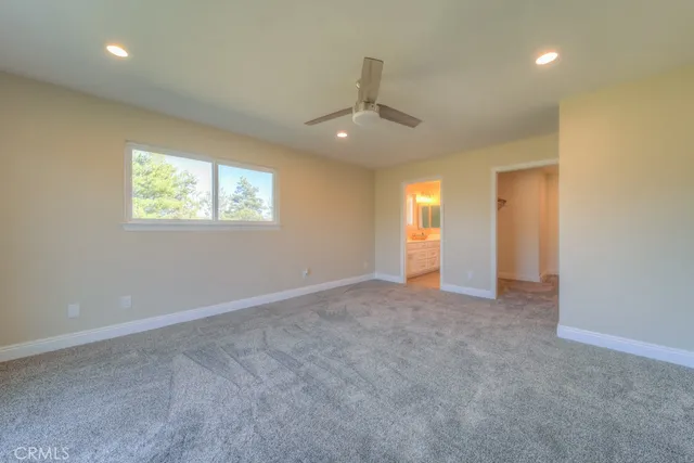 a bathroom with a granite countertop sink a toilet and shower
