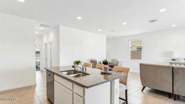 a kitchen with stainless steel appliances kitchen island granite countertop a sink and cabinets