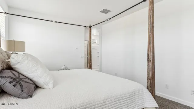 a bedroom with a bed and a white walk in closet