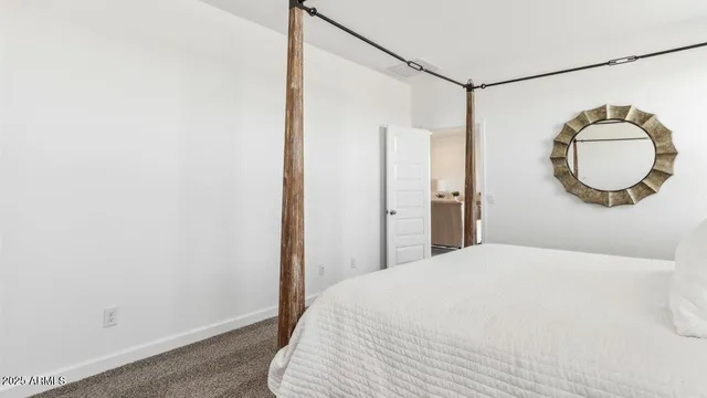 a bedroom with a bed and a mirror