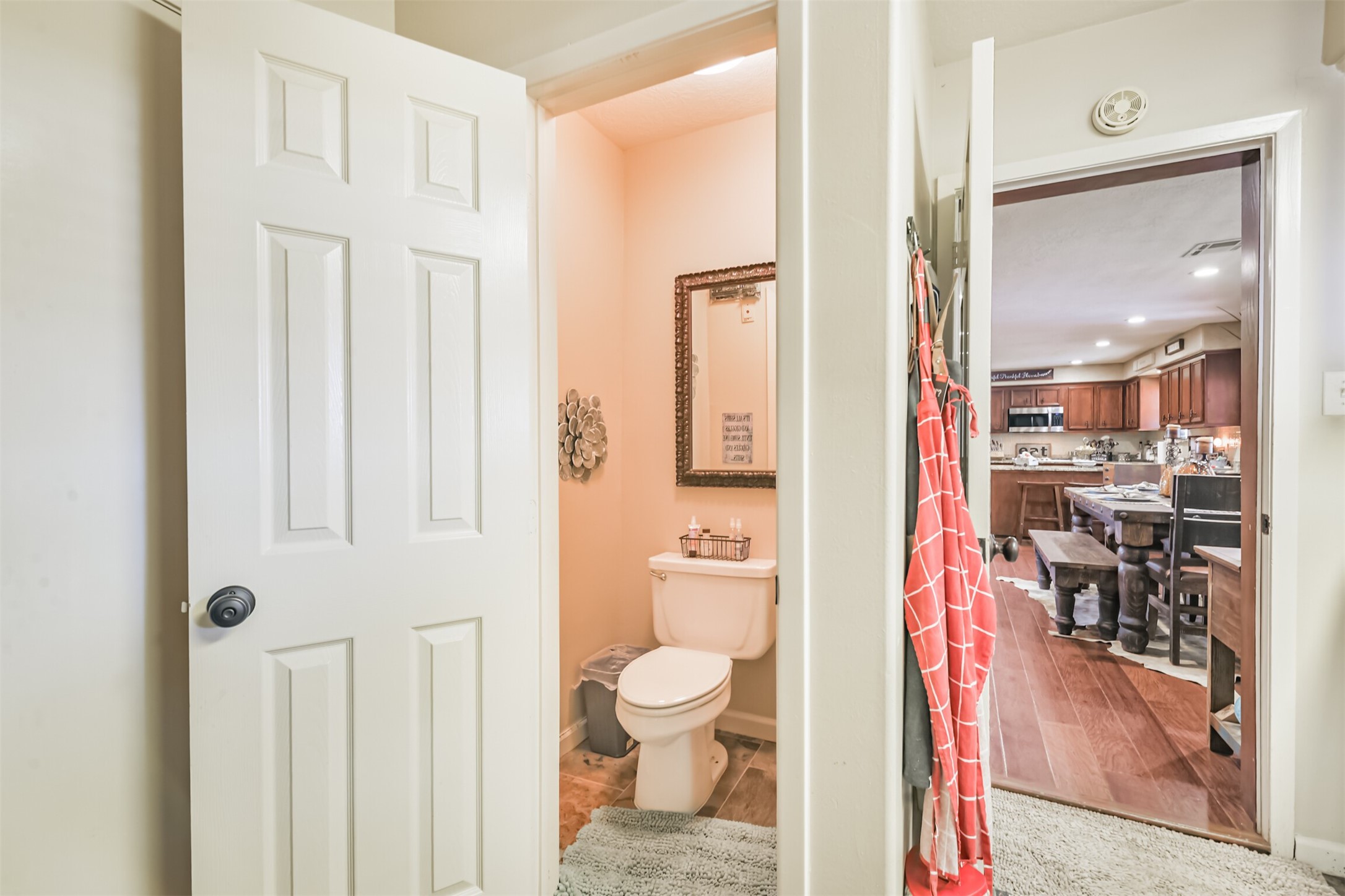 307 West Hufsmith Road Tomball, TX 77375 - Photo 30 of 44 Cozy bathroom with elegant decor, seamlessly connected to a spacious kitchen featuring rich wooden cabinetry and modern appliances.