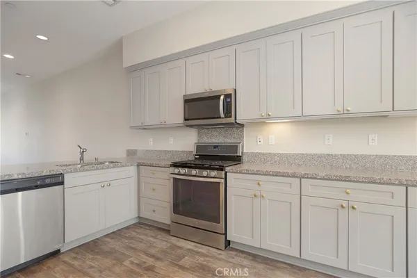 a kitchen with white cabinets and a stove top oven