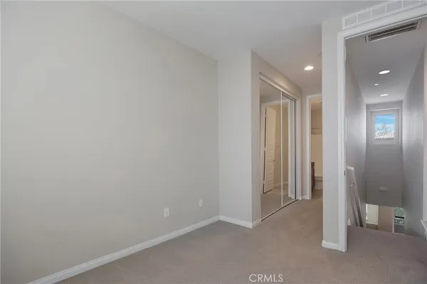 a view of an empty room and closet area